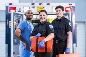 First Responders standing in front of an ambulance