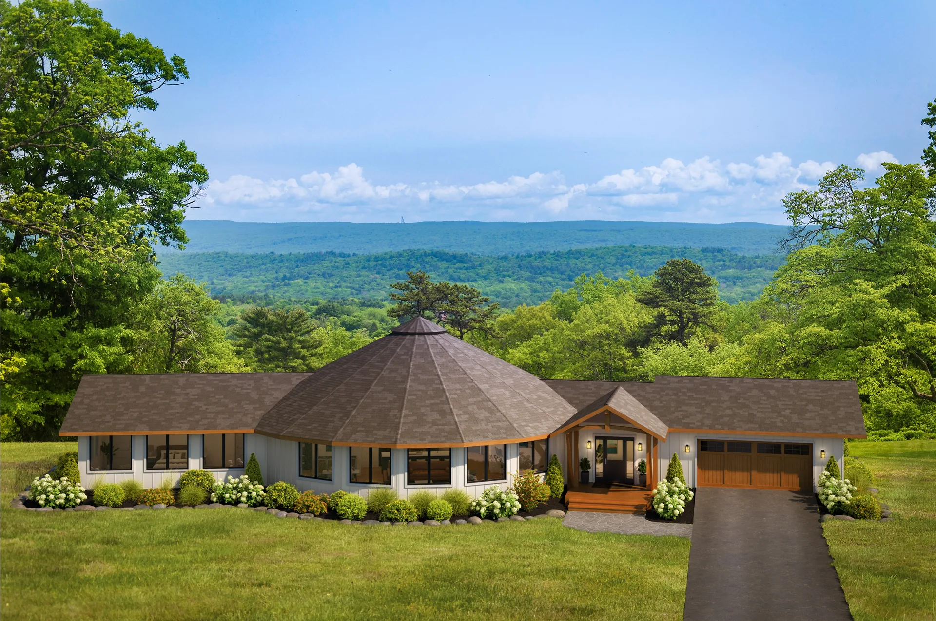 Crest round home with an attached garage, surrounded by green mountains and trees